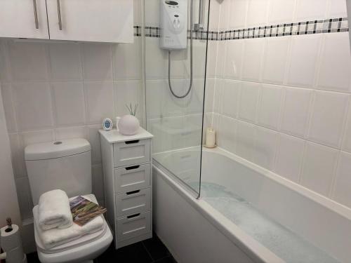 a bathroom with a shower and a toilet and a tub at 2 Bed in Morecambe oc-93719 in Heysham