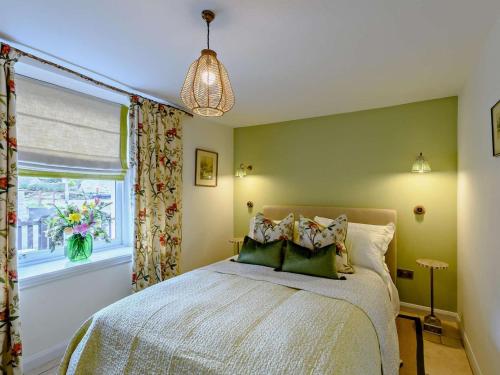 a bedroom with a bed and a window at 1 Bed in Hawick oc-91437 in Denholm