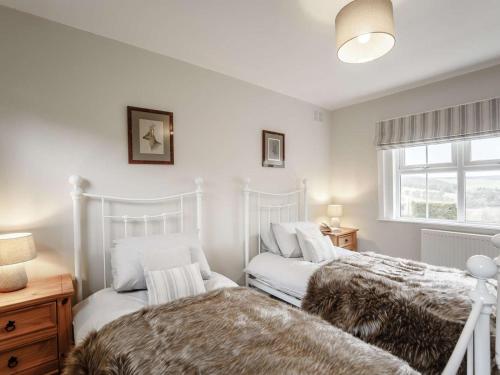 two beds sitting next to each other in a bedroom at 2 Bed in Duns oc-82759 in Duns