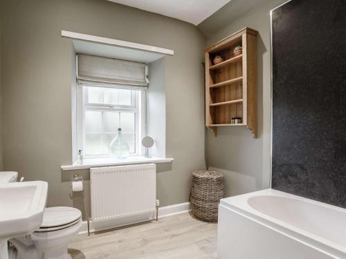 a bathroom with a toilet and a sink and a window at 2 Bed in Duns oc-82759 in Duns