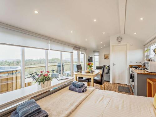 a room with a bed and a desk and a kitchen at 1 Bed in Dalry oc-91417 in Dalry