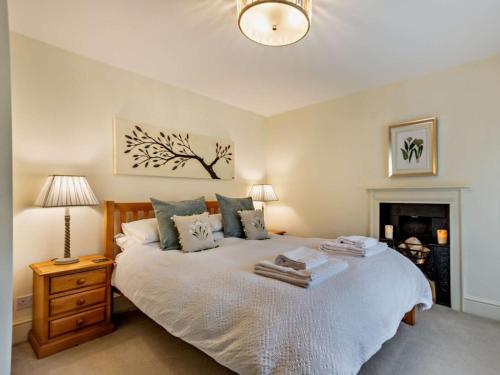a bedroom with a bed and a lamp and a fireplace at 3 Bed in Middleham oc-78935 in Middleham