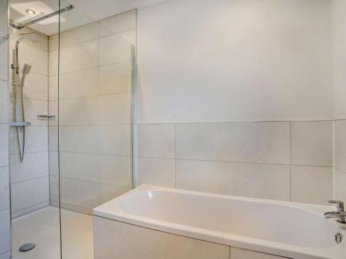 a bathroom with a tub and a glass shower at 3 Bed in Swansea oc-91720 in Killay