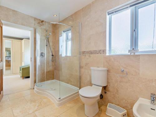 a bathroom with a toilet and a shower and a sink at 2 Bed in Cartmel oc-lcc47 in Cartmel
