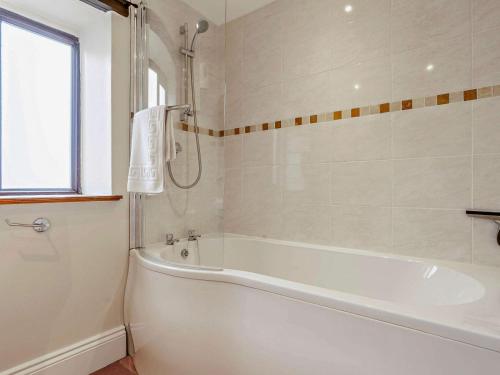 a white bath tub in a bathroom with a window at 2 Bed in Barnard Castle oc-90498 in Middleton in Teesdale