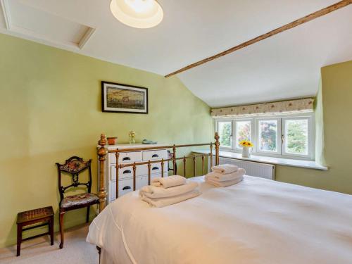 a bedroom with a large bed with two towels on it at 4 Bed in Kendal oc-sz535 in Kentmere