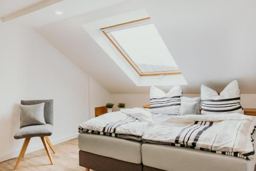 a bedroom with a bed with a skylight at Lago Edera - Seeblick in Hemfurth-Edersee