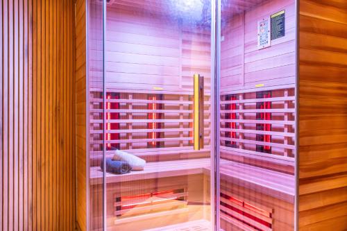 a glass shower in a bathroom with red wine bottles at Lago Edera - Talblick in Hemfurth-Edersee