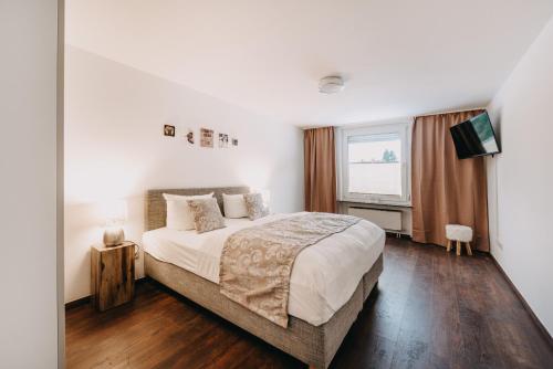 a bedroom with a large bed and a window at Wolfswarte in Braunlage
