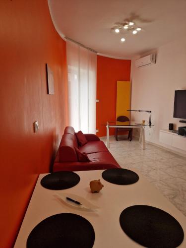 a living room with a red couch and a table at Palazzo interno 3 in Giovinazzo