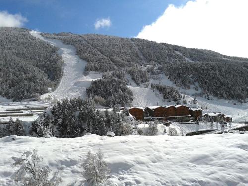 a train in the snow on a snowy mountain at AC Apartaments Sol Tarter in El Tarter