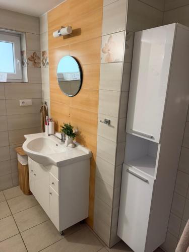 a bathroom with a sink and a refrigerator at Chata pod loukou in Tvarožná Lhota