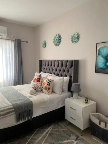 a bedroom with a large bed with pillows on it at Naledi Inn in Gaborone