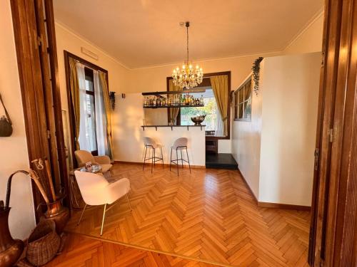 a living room with a table and chairs and a kitchen at Hotel La Fontana in Stresa