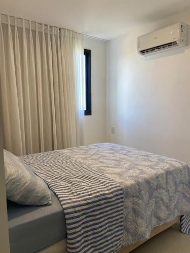 a bedroom with a bed with a blanket on it at Vila confort in Vila Velha