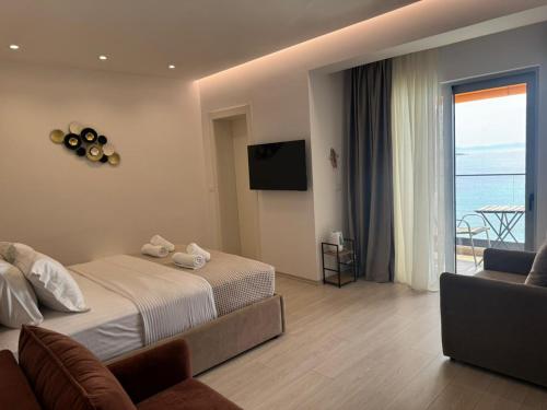 a hotel room with a bed and a television at Hotel Veizi in Himare