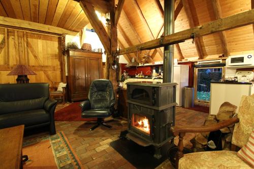 a fireplace in a living room with a stove at "Ni-jland" in Winterswijk