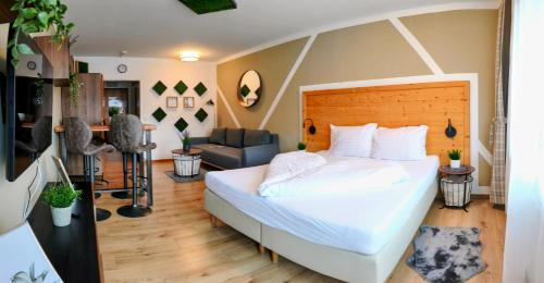 a bedroom with a bed and a living room at Stelo Appartments in Gosau