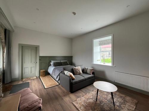 a living room with a couch and a bed at Crossdrum Courtyard Accommodation in Oldcastle