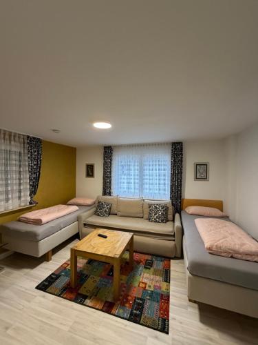 a living room with a couch and a table at Apartments Metzingen Panoramablick in Metzingen