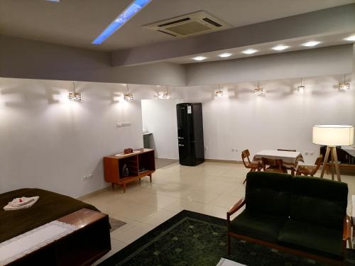 a room with a bed and a couch and a table at Center Apartment in Przemyśl