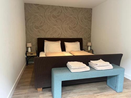 a bedroom with a bed and a table with towels at Gastenverblijf Bladel in Bladel
