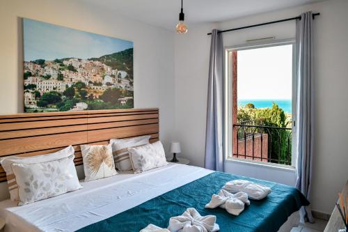a bedroom with a bed with a large window at Super appartement à lumio in Lumio