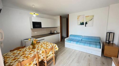 a living room with a blue couch and a table at Lake Garda Apartment - Panorama in Brenzone sul Garda