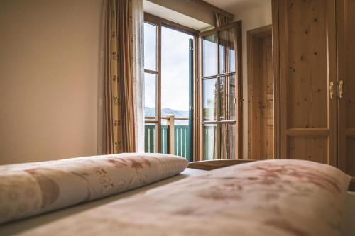a bedroom with a bed with a large window at Weingut Gaube in Leutschach