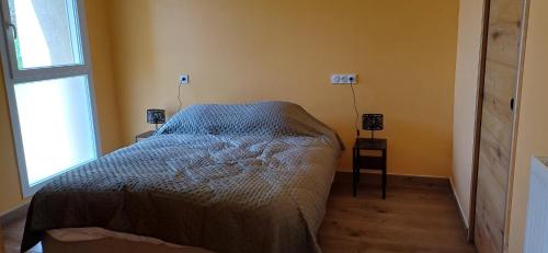 a bedroom with a bed and a window at Logis de la Provosterie CLICRO in Ahuillé