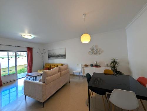 a living room with a couch and a table at 5B Sra da Rocha - Casas & Papeis in Armação de Pêra