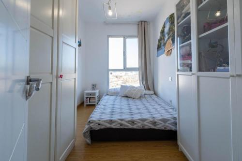 a bedroom with a bed in a room with a window at Casa Atardecer in Moya