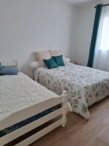 two beds sitting next to each other in a bedroom at Villa Goyavier in La Plaine des Palmistes