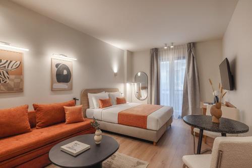a hotel room with a bed and a couch at Leon by Zoia Living in Piraeus