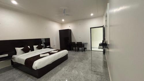 a bedroom with a large bed and a table at The Backpacker hostel by Surendra rajak in Khajurāho