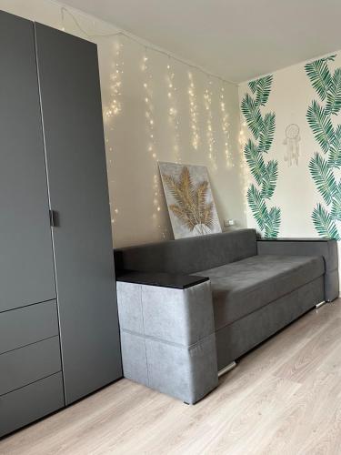 a room with a bed and a wall with lights at Затишна трьохкімнатна квартира у Львові in Lviv