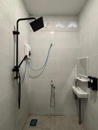 a bathroom with a shower and a sink at D' Ehsan Homestay & Chalet in Kuala Terengganu