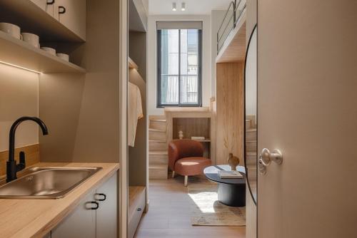 a bathroom with a sink and a toilet in a room at Leon by Zoia Living in Piraeus