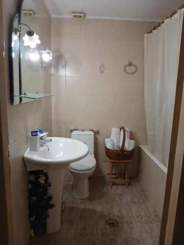 a bathroom with a sink and a toilet and a tub at Blue Hour in Monemvasia