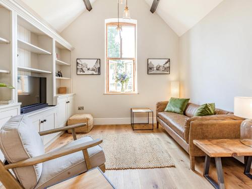 a living room with a couch and a tv at The Old Workshop - Cottage in Broom