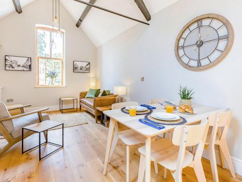 a dining room and living room with a table and chairs at The Old Workshop - Cottage in Broom