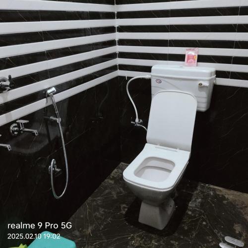 a bathroom with a toilet and a shower at Shree krishna guest House near Ram mandir in Ayodhya