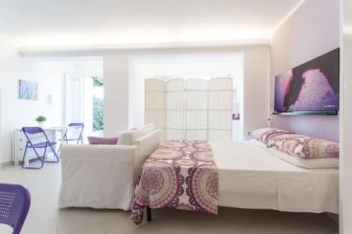 A bed or beds in a room at Mondello Suites FLH - Gorgonia