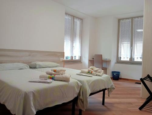 a bedroom with two beds with towels on them at Il Glicine B&b in Voltaggio