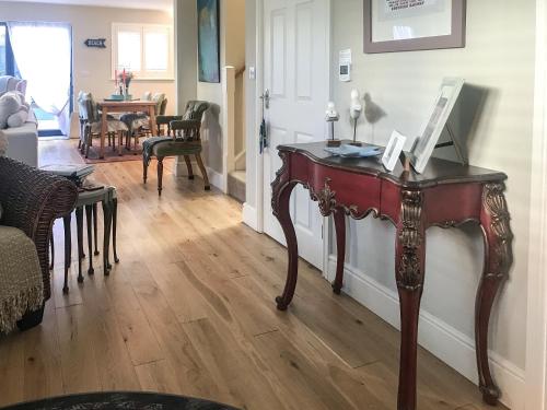a living room with a wooden table in a room at The Coach House in Whitstable
