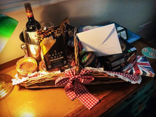 a wicker basket with a bottle of wine and a gift at The Coach House in Whitstable