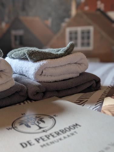 a pile of towels sitting on top of a box at Brasserie de Peperboom in Veere