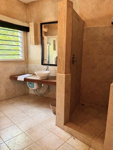 a bathroom with a sink and a shower at Lawford Apartment Malindi in Malindi