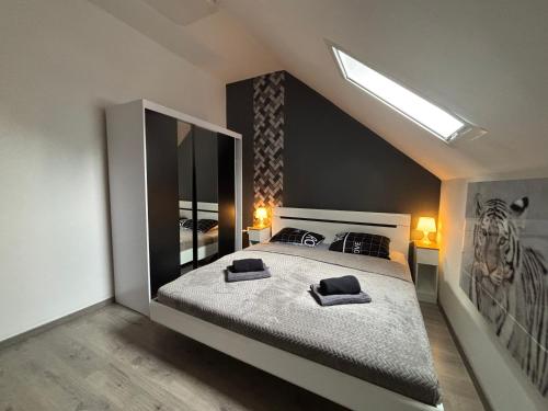 a bedroom with a large bed with two pillows on it at LUX Pool Villa Zamárdi in Zamárdi