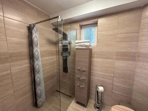 a shower with a glass door in a bathroom at LUX Pool Villa Zamárdi in Zamárdi